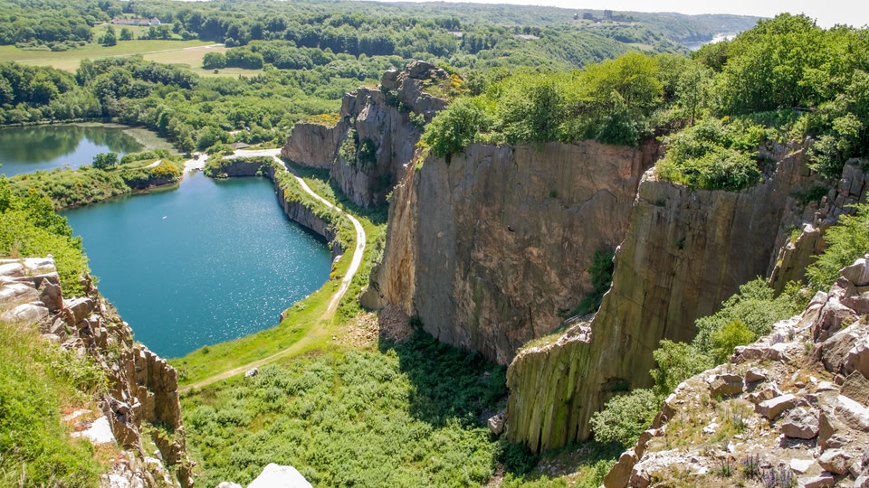 Rugged cliffs, greenery and blue lakes in Bornholm.