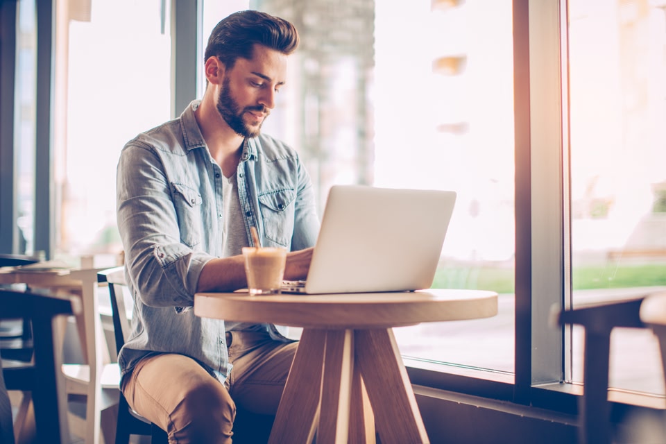 카페에 앉아 일하는 사람