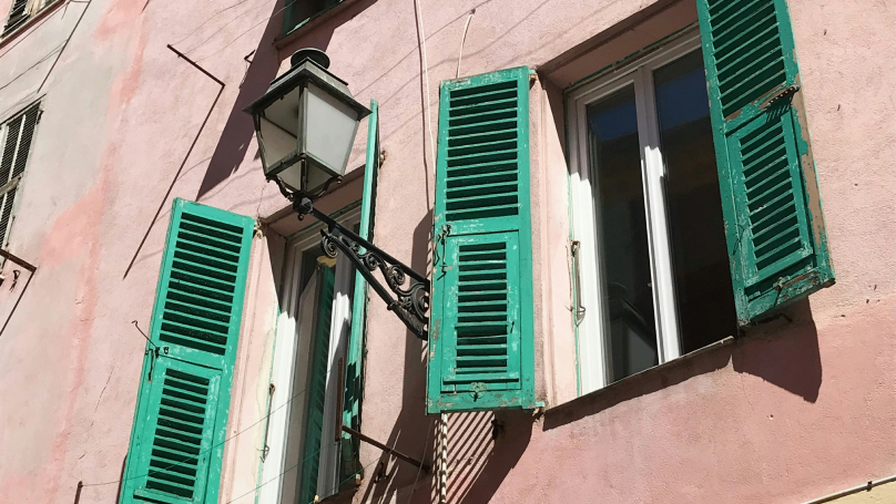 A picture of some French windows with rustic shutters.