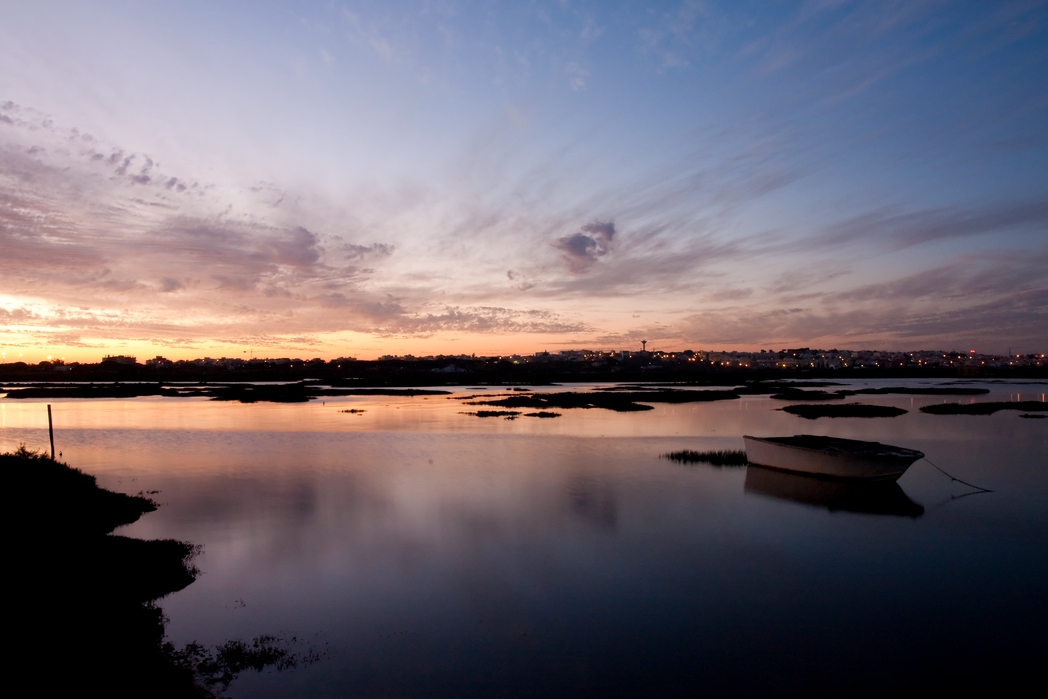 Lake with boat in the Rio Formosa National Park near Faro, Algarve