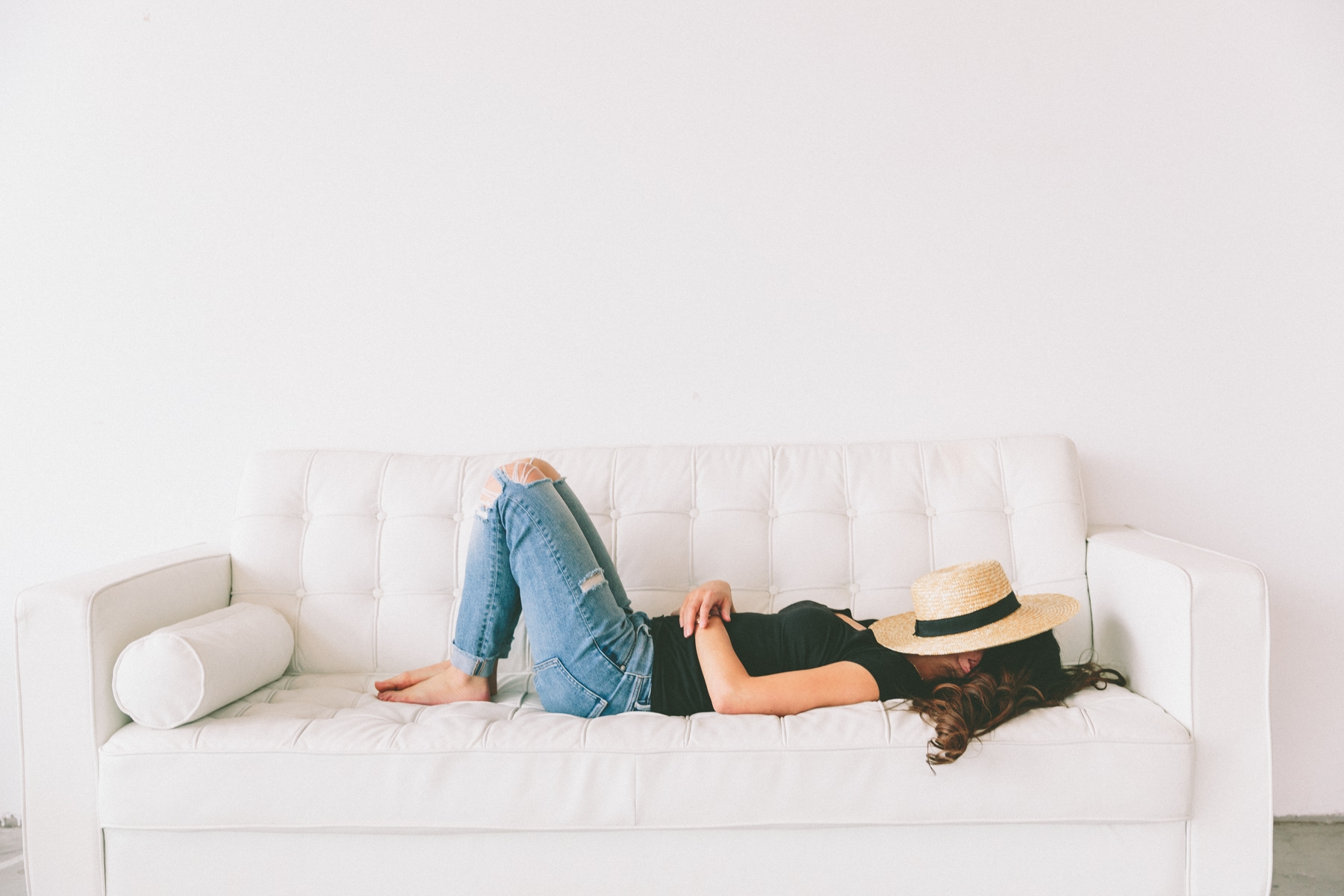 girl laying on couch dreaming of travel