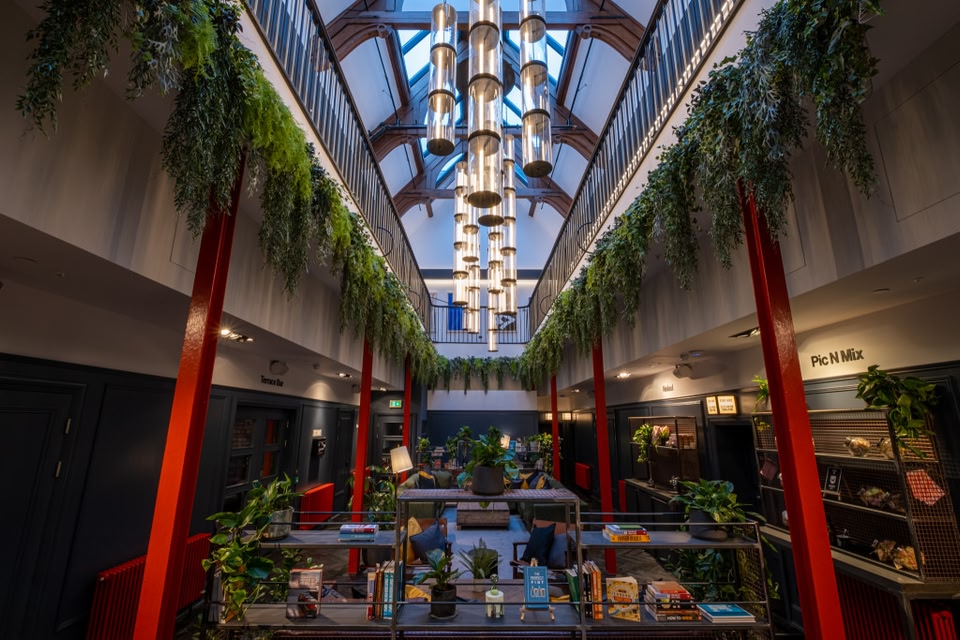 Communal area of BrewDog DogHouse Hotel, Edinburgh, with lots of plants an a 24 hour Pic N Mix wall.
