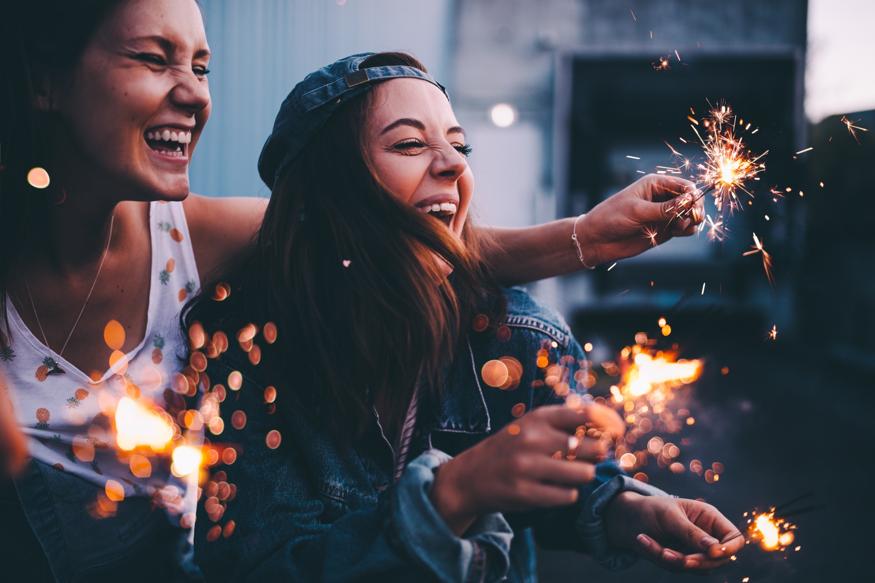 Young women with sparklers celebrating fourth of July.