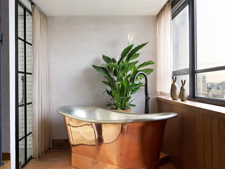 Copper bathtub in the bathroom at Treehouse Hotel London