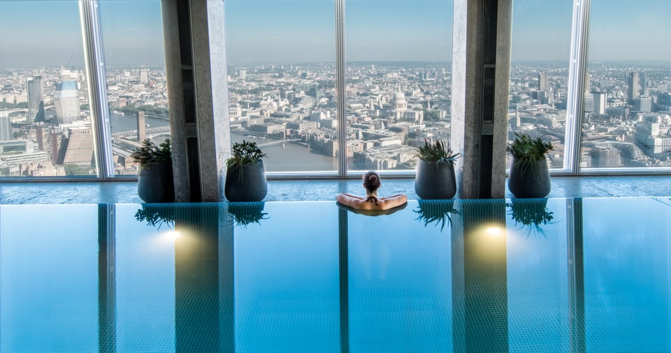 Woman enjoying the view across London from the Shangri-La The Shard infinity pool.