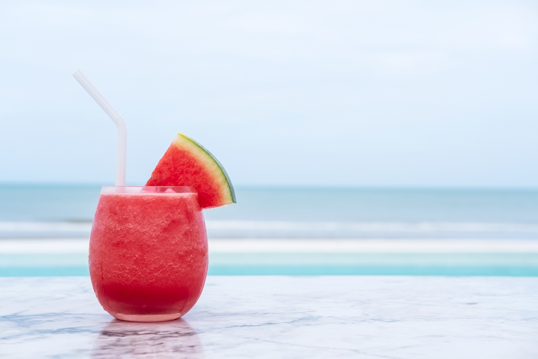 Watermelon smoothie on blue tropical beach. Summer holiday concept.