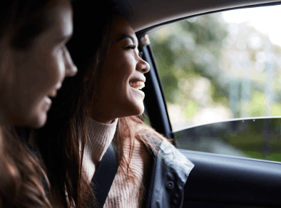 Friends share a laugh on a car