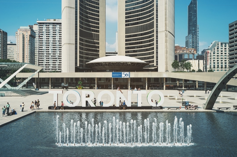 Toronto sign by fountain in Nathan Phillips Square