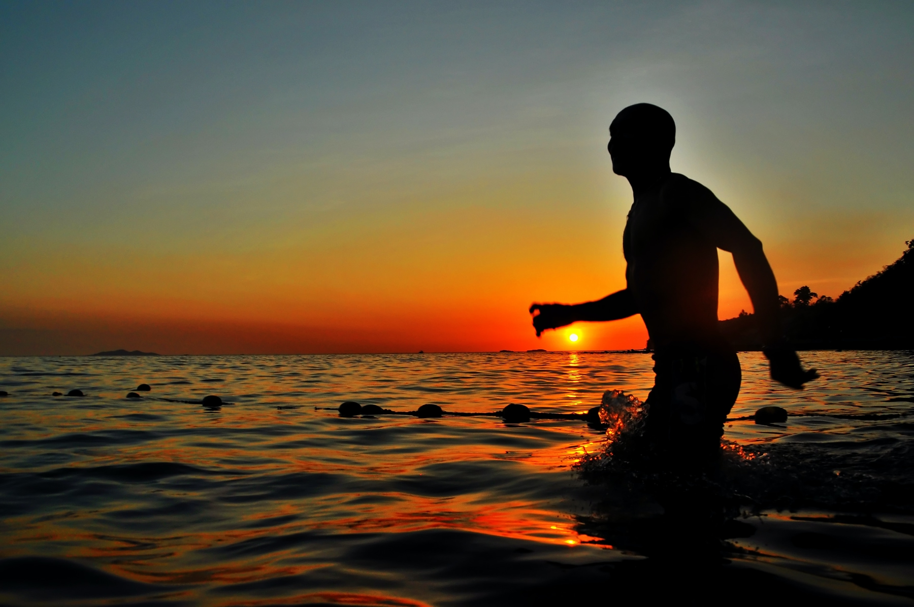silhouette of a surfer at a beach in Costa Rica during sunset along the Pacific coast.