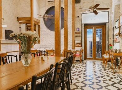 Elegant dining area featuring a tastefully decorated table adorned with a beautiful vase of white flowers, creating a sophisticated and inviting atmosphere.