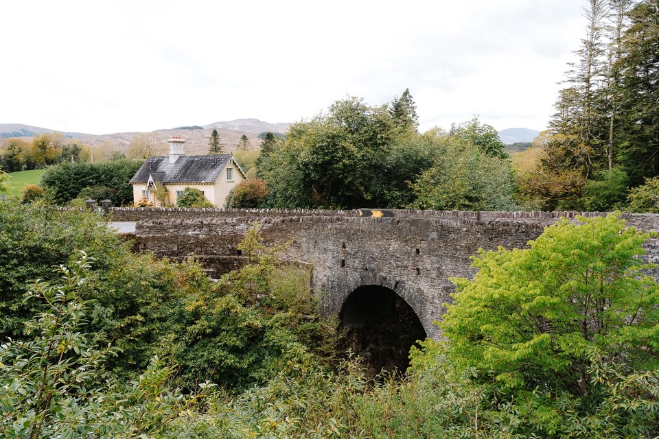 View of old bridge with cottage next to the road along Kerry Way