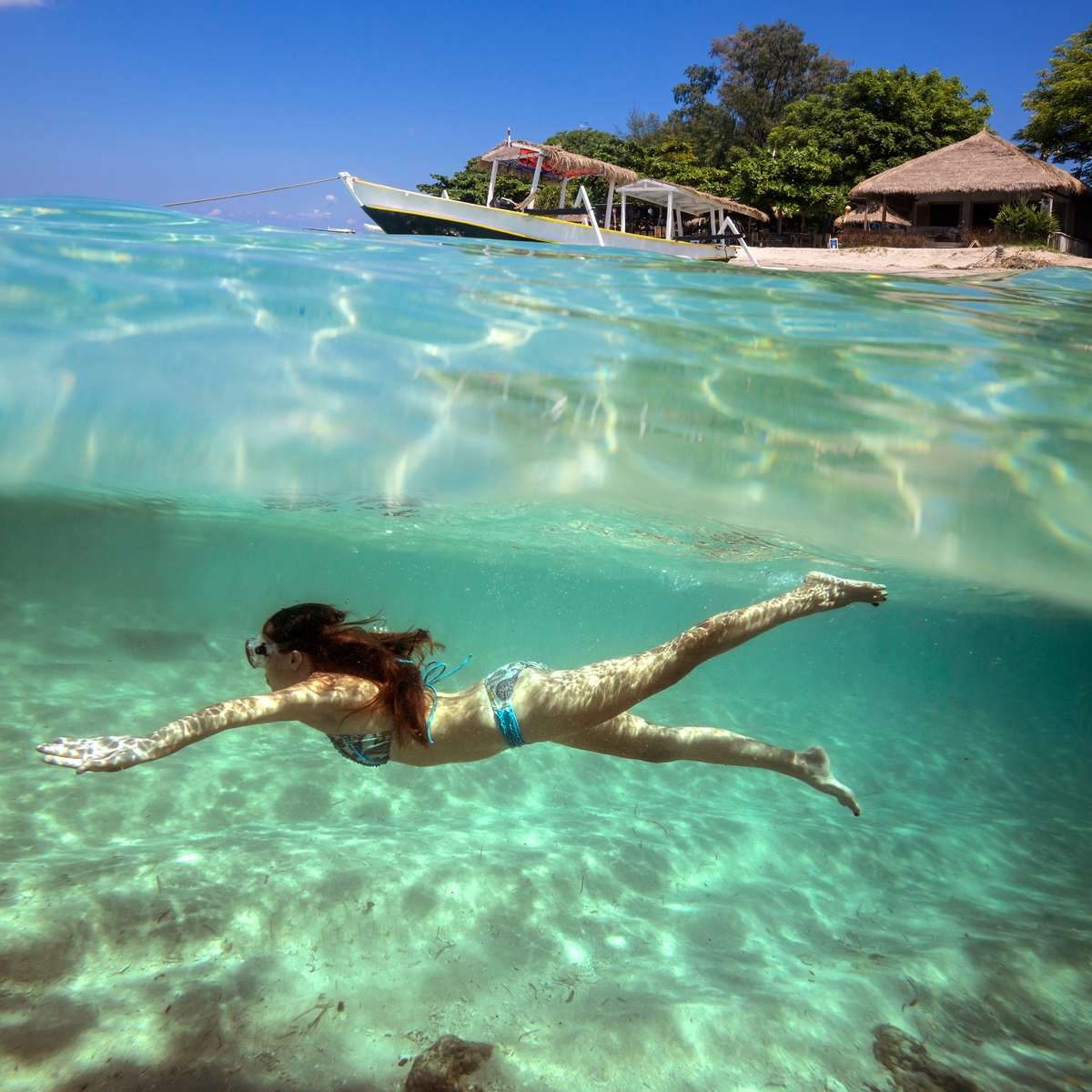 Woman swimming in Bali - 10 cheap holiday destinations