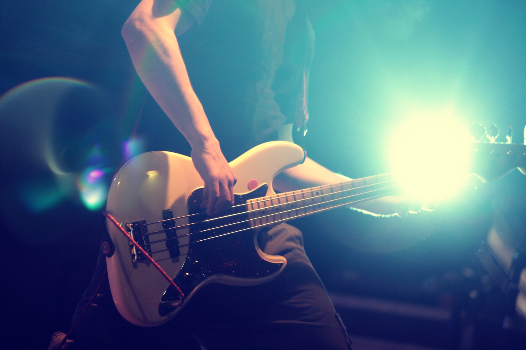Close-up of guitar player on stage