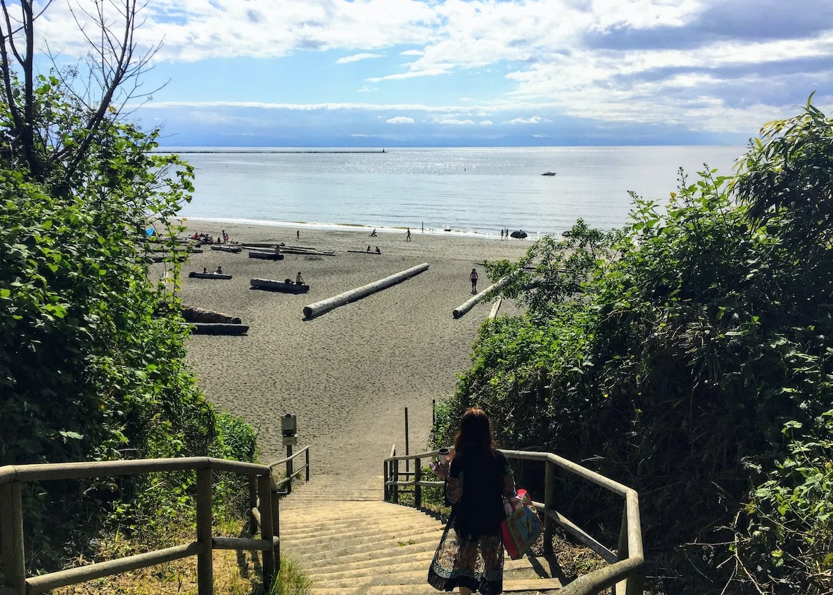 woman walking down the steps to Wreck Beach, the best for nude beaches in Vancouver and all of Canada. 