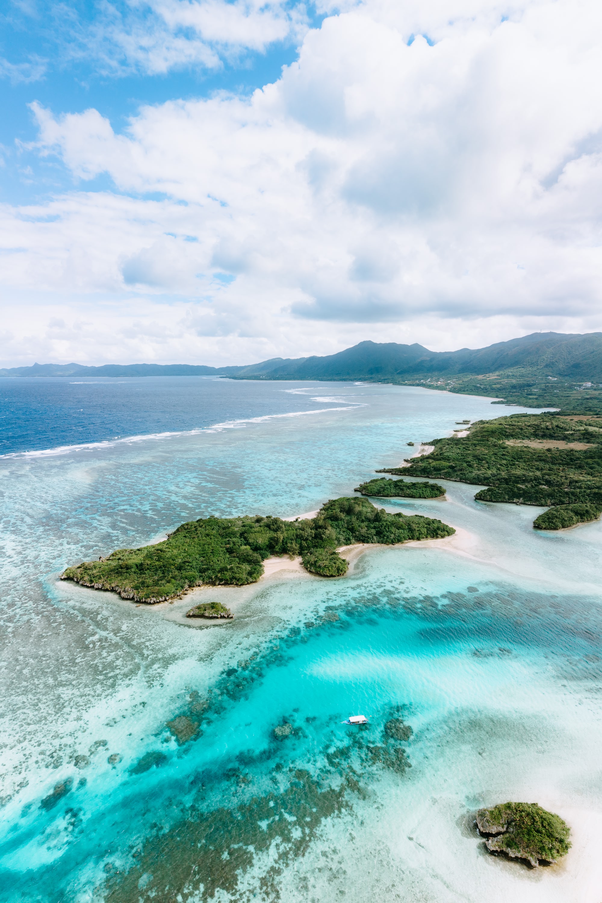 Aerial view of tropical island beach and clear blue water with coral reef, Kabira Bay, Ishigaki Island of the Yaeyama Islands, Okinawa, Japan