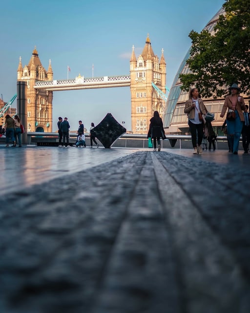ground shot of the London Bridge in the distance during the day, blue sky.