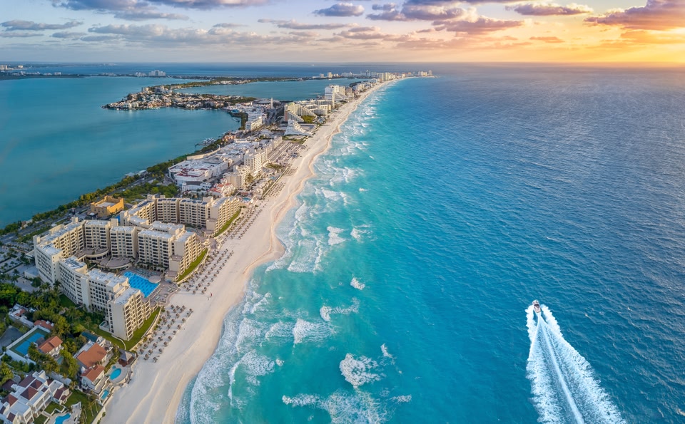 Bird's-eye view of a strip of beaches with water on either side.