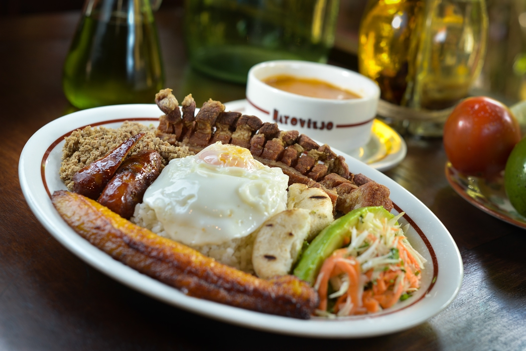 Bandeja Paisa with plantain, fried egg, rice, sausage and more - tasty reasons to visit Colombia