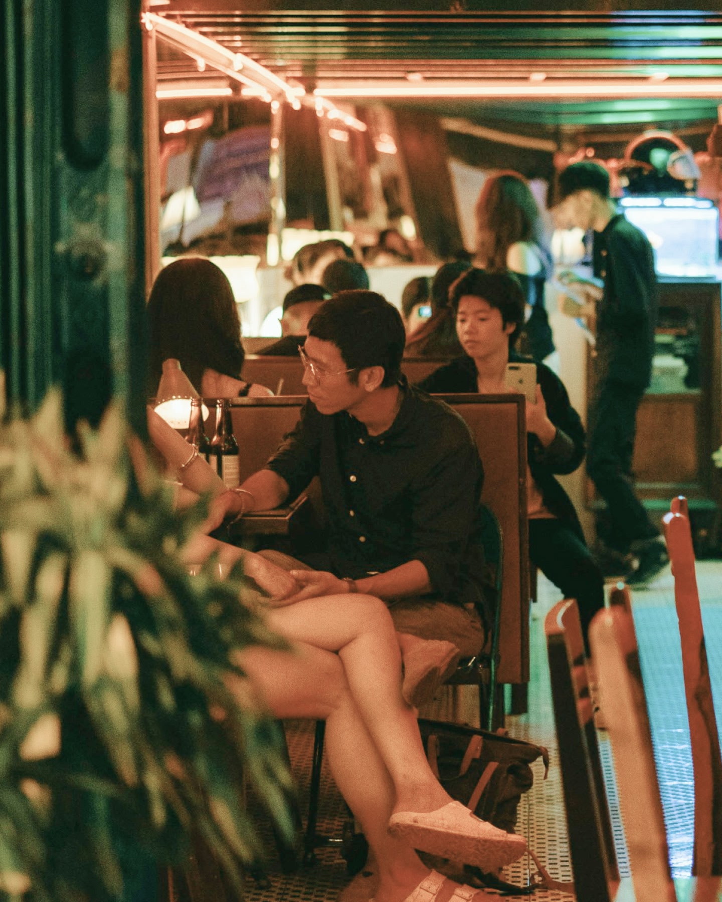 Busy bar in Asia with couple sitting in a booth