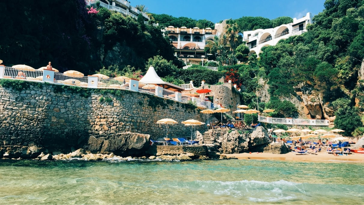 een afbeelding van een prachtig strand met enkele mensen overdag dichtbij Rome