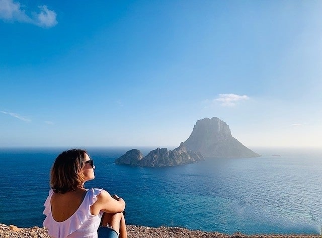 Girl sitting by the sea on Ibiza