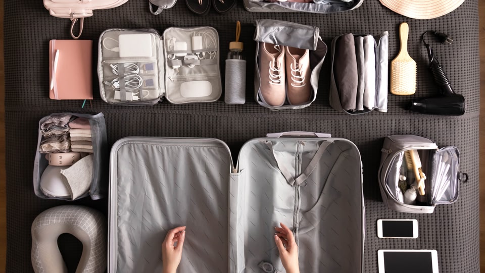 items carefully laid outside of an open suitcase