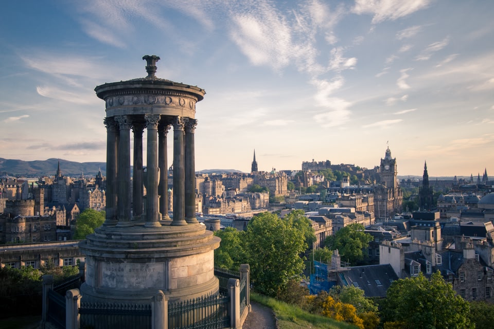 View of Edinburgh from the top of Calton Hill, taking in the Dugald Stewart monument in the foreground and Edinburgh Castle in the distance.
