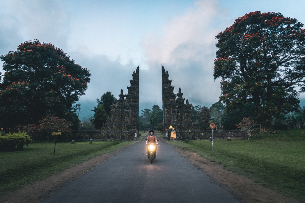 Man driving a motorbike in Bali - travel insurance, is it worth it?