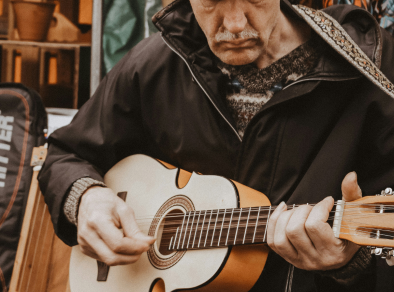 An old man playing a guitar