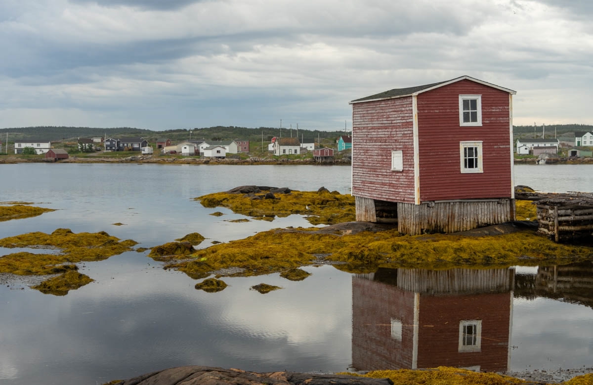 a painted red fishing stage by the shore in central Newfoundland