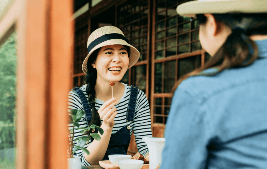 Two women enjoying tea and each other company in a traditional Japanese setting. 