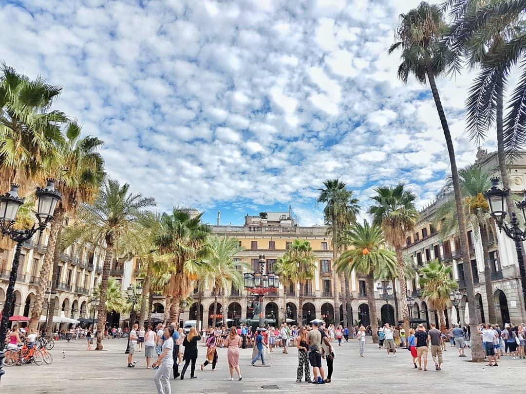 A square full people. Walking tours are one of the best free things to do in Barcelona