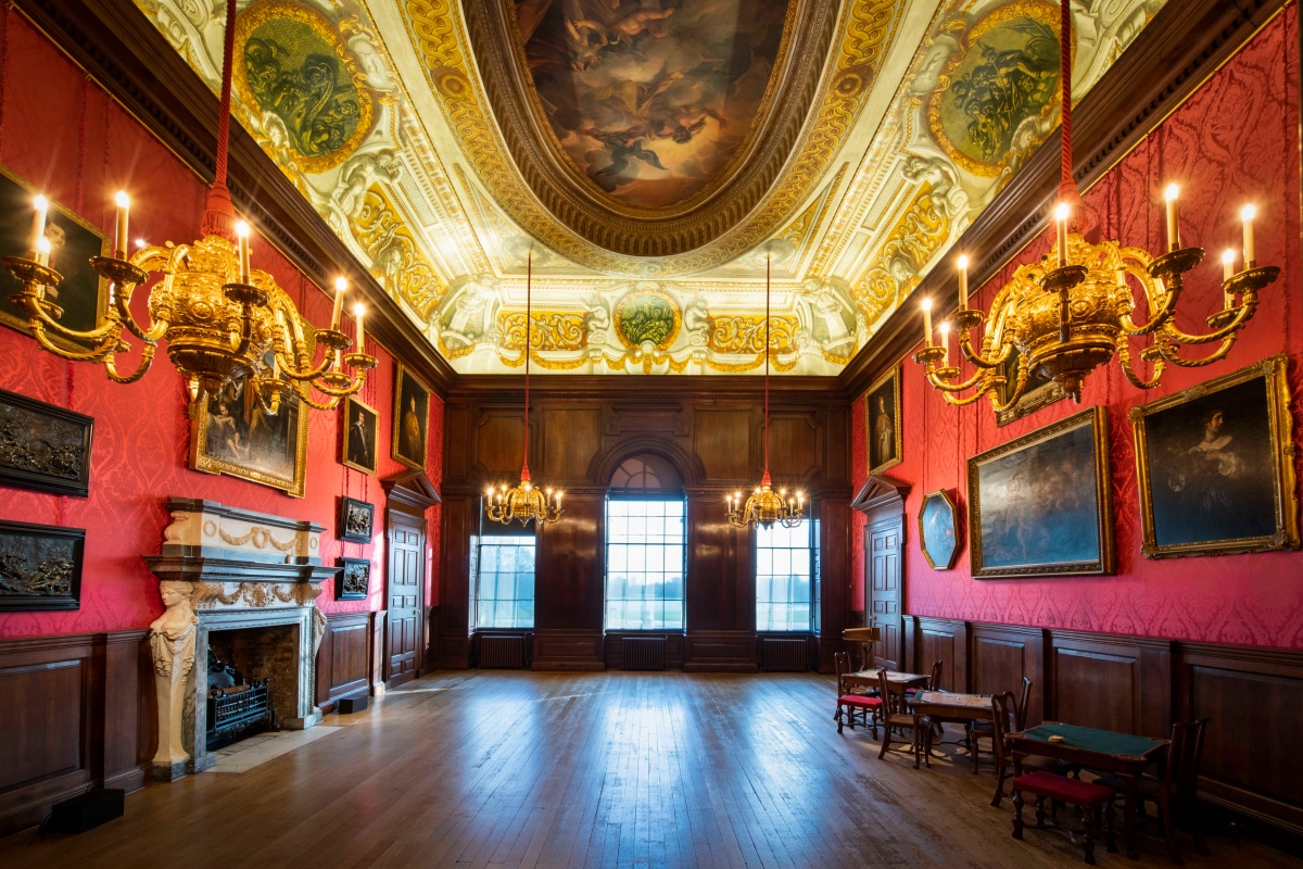 Grand room with painted ceilings, chandeliers and ornate fixtures at Kensington Palace, London.