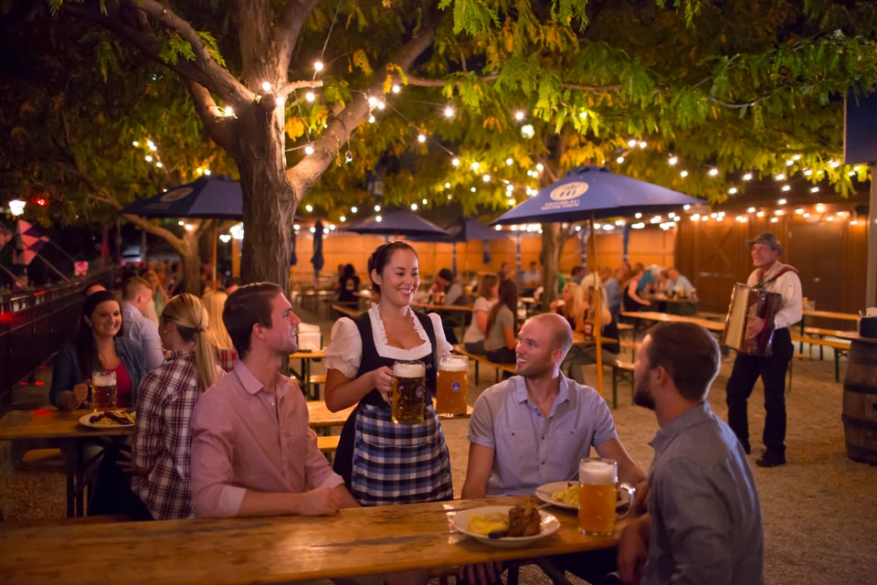 Group of young men being served beer in a German-style biergarten in Cincinatti