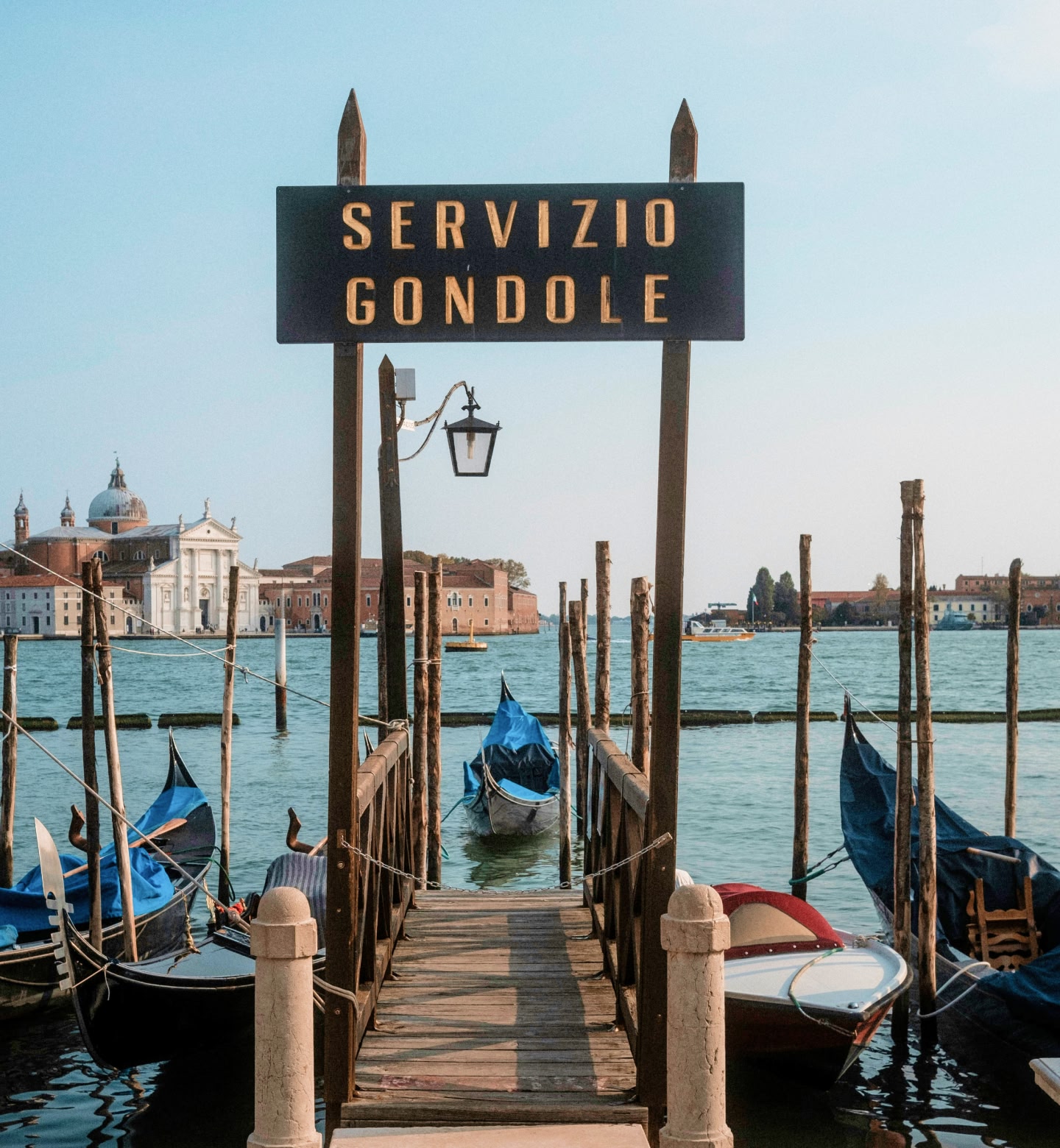Gondolas docked on calm waters near San Giorgio Maggiore, Venice.