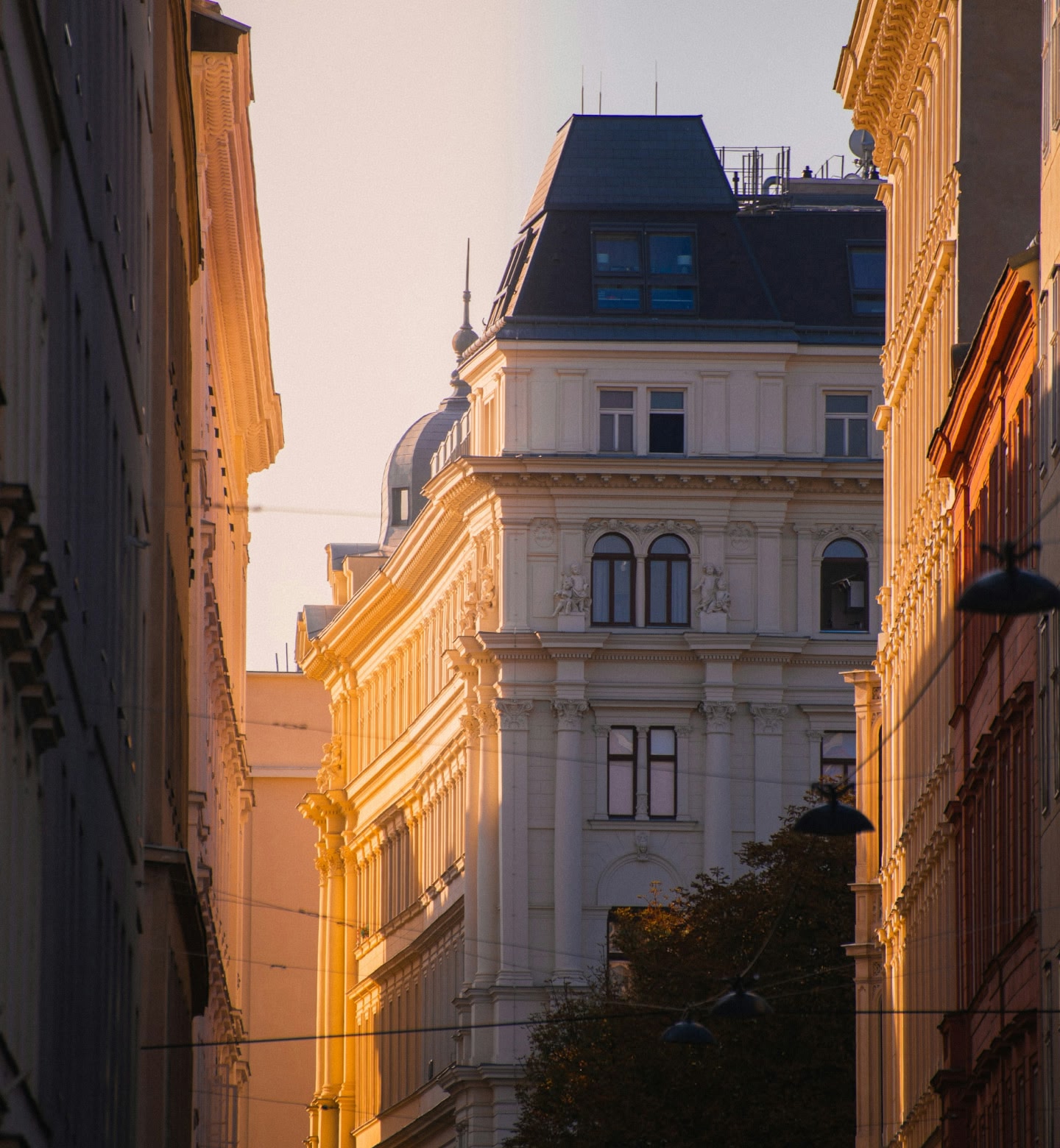 Golden light falls on ornate architecture in Vienna, Austria