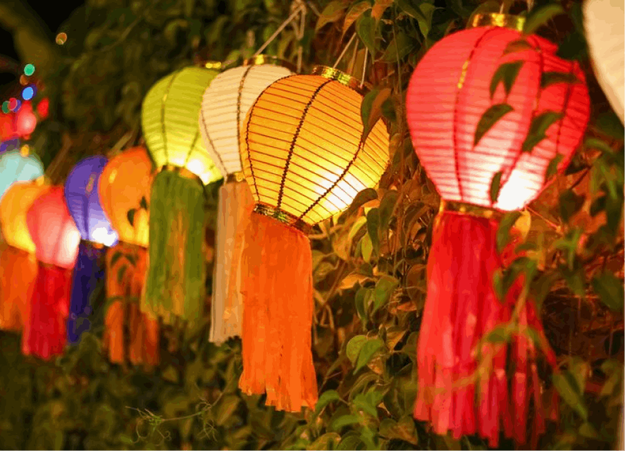 A row of paper lanterns along a hedge
