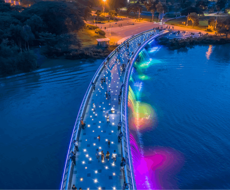An areal shot of a Ho Chi Minh foot bridge in the dark illuminated by lights