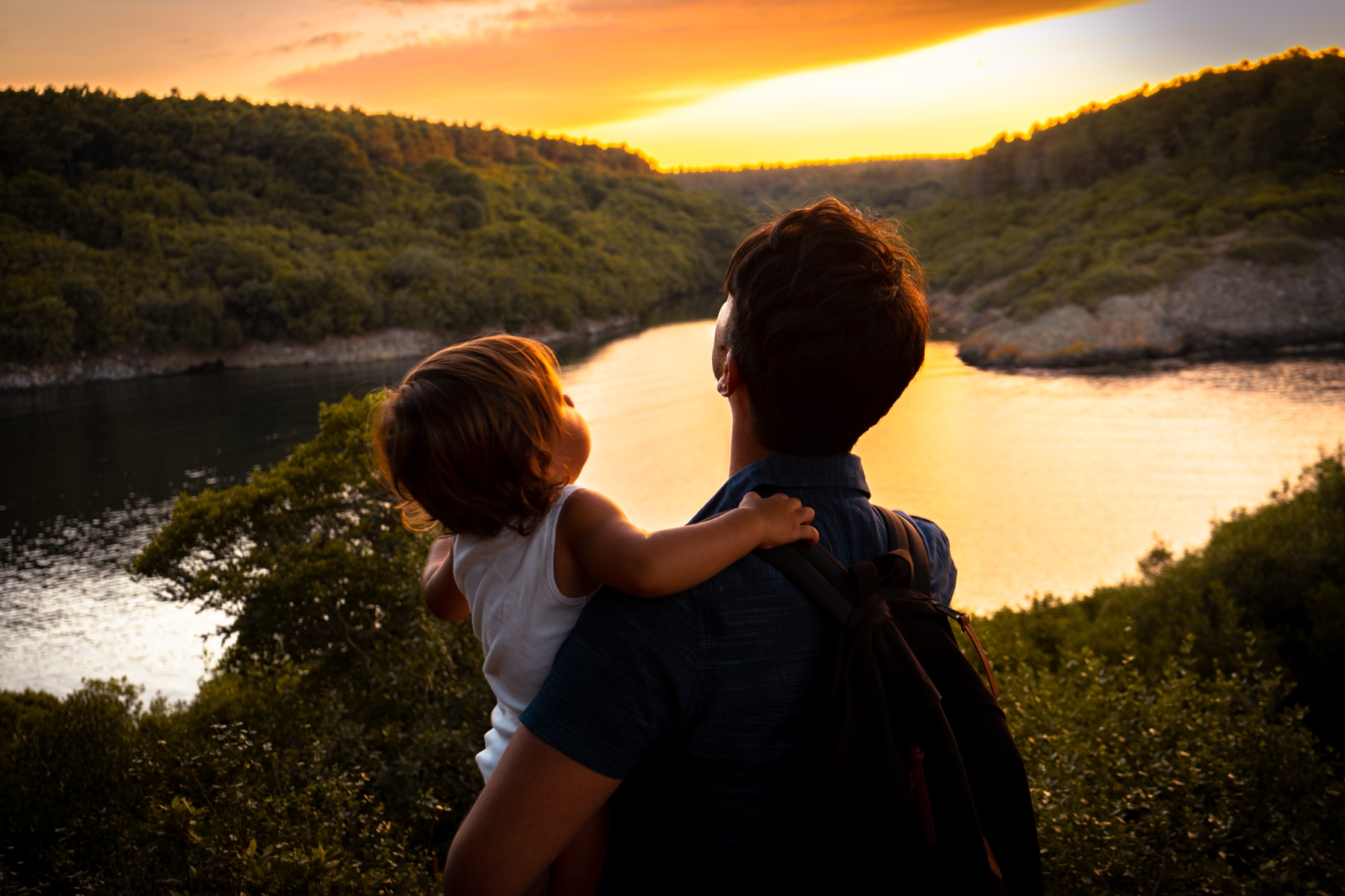 A father and sun looking at a lake