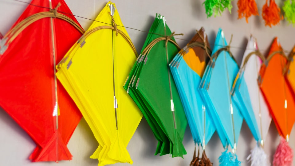 image of colourful kites hanging on a wall side-by-side