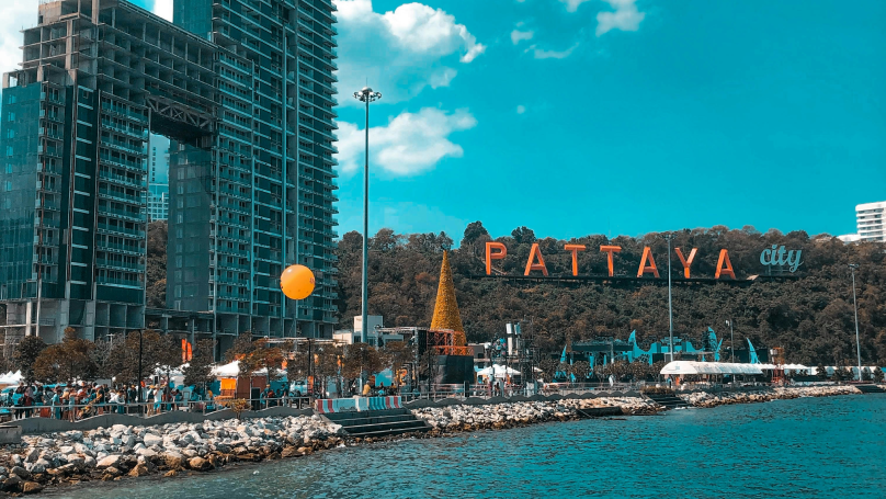 Beach close to buildings in Pattaya city during daytime.