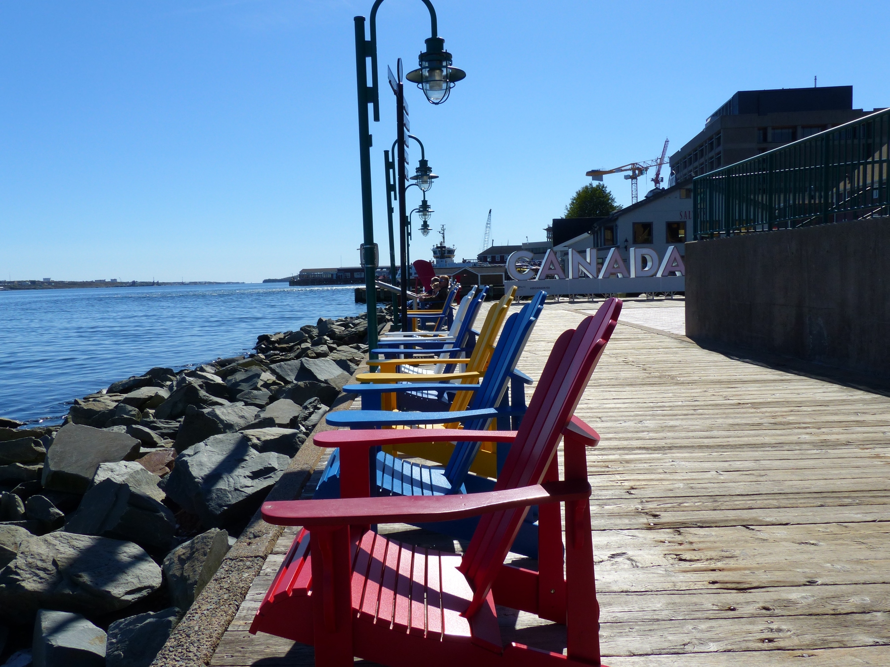 Muskoka chairs by the coast in Halifax, Nova Scotia