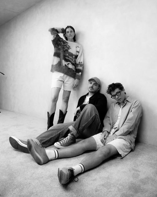 Members of the indie pop group Valley - one member is standing up, others sitting down