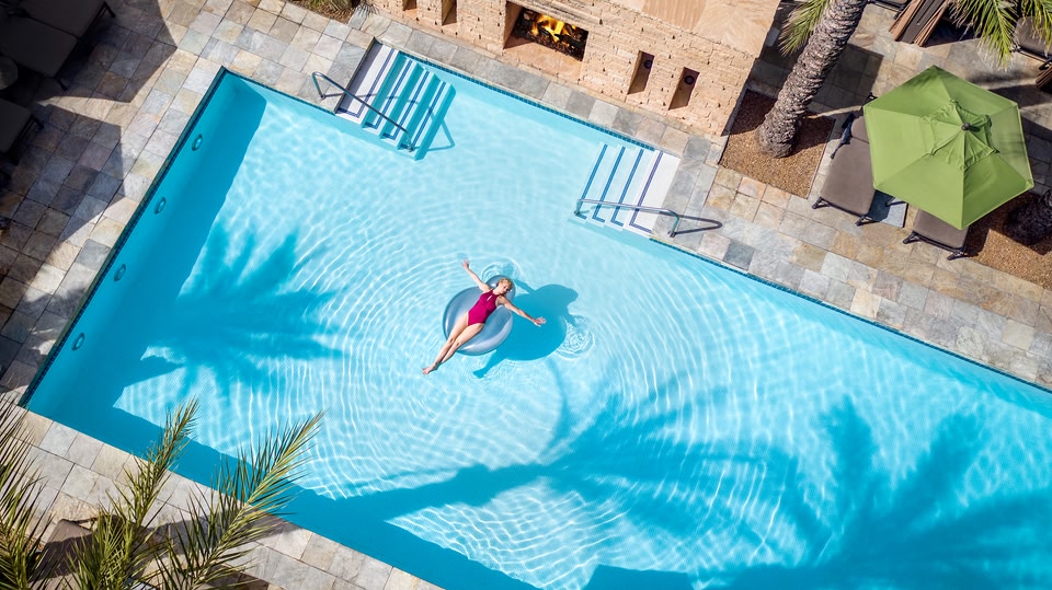 Woman lying on an inflatable in a pool in Scottsdale, Arizona.