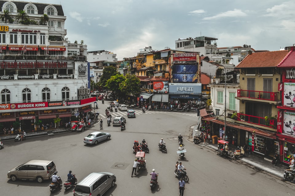 motorbikes on busy intersection in downtown Hanoi, Vietnam. Hanoi is an ideal destination to travel to in October.
