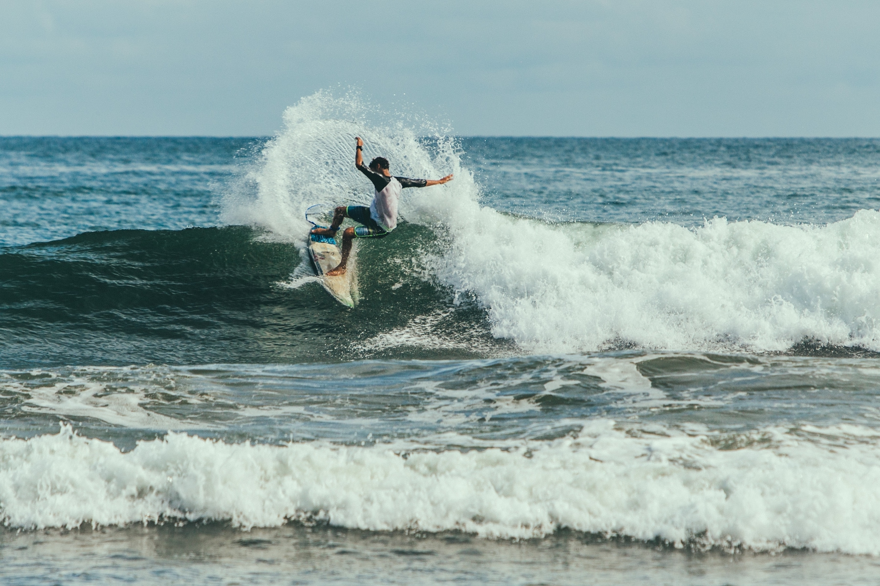 A surfer catching waves in Playa Venao, Panama, one of the best alternative nature destinations.