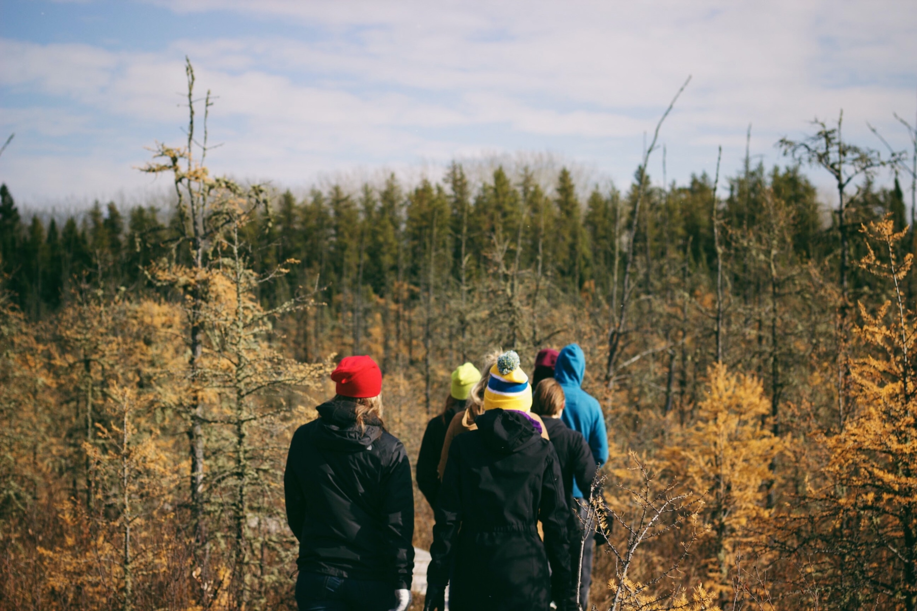 family hiking in the woods near Waskesiu Lake in Saskatchewan, a good spot for a staycation