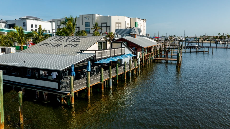 Aerial view of a coastal town with numerous buildings and boats in the water.