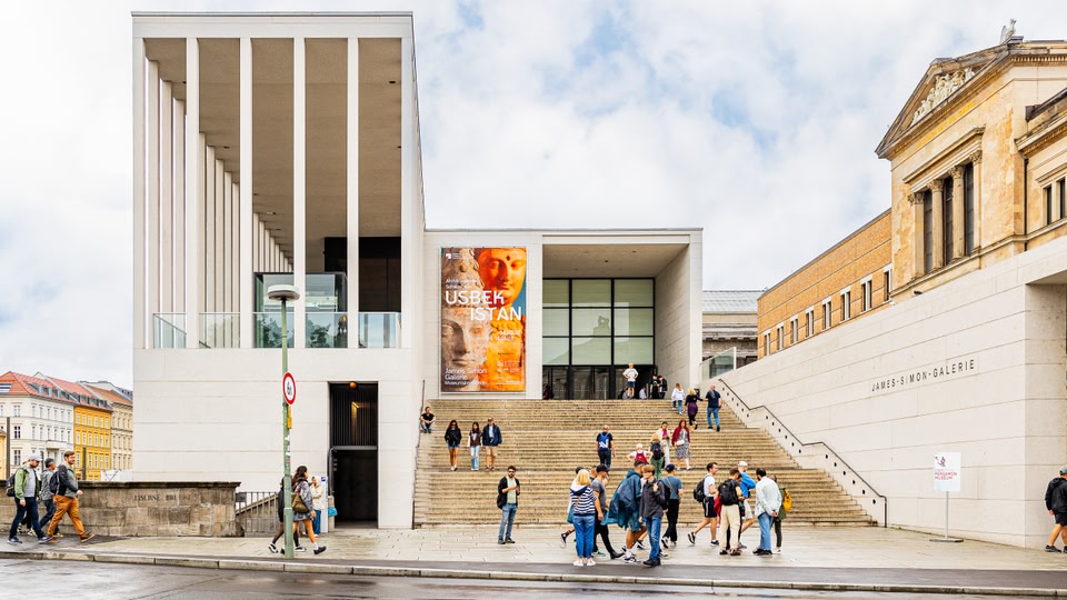 Visitors walking up the steps towards the entrance of the Pergamonmuseum in Berlin.