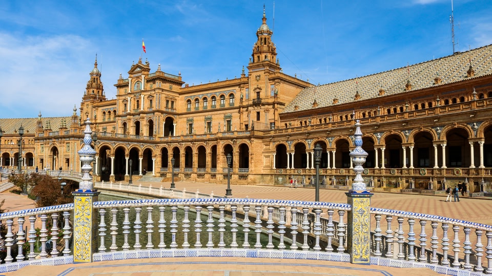 A grand historical building with intricate design and architecture, located in Seville, Spain.